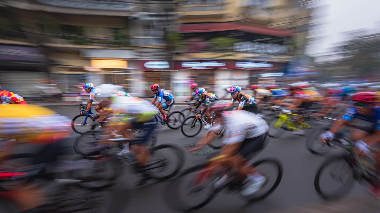 Elite cyclist demonstrating the explosive power and technical skill needed to compete in both one-day Monument classics and Grand Tour stage races
