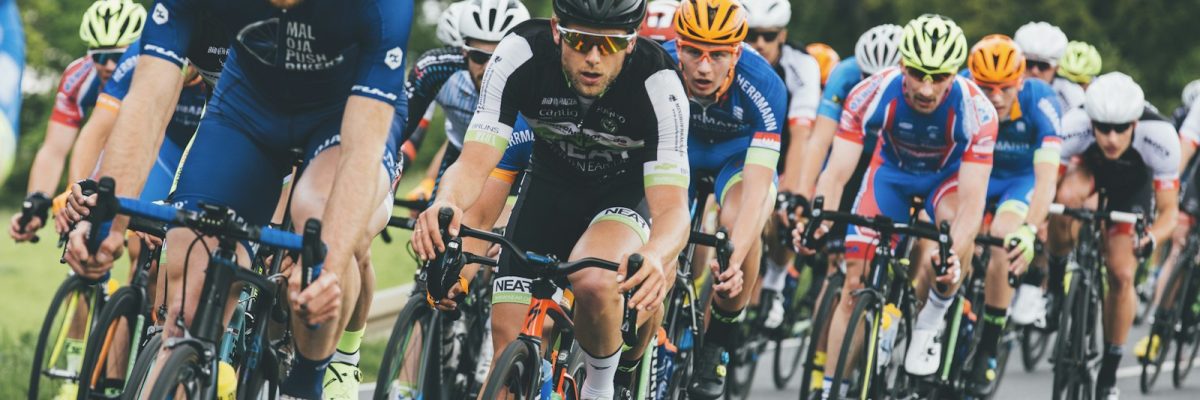 Large professional cycling peloton showing how riders cluster together to benefit from the draft