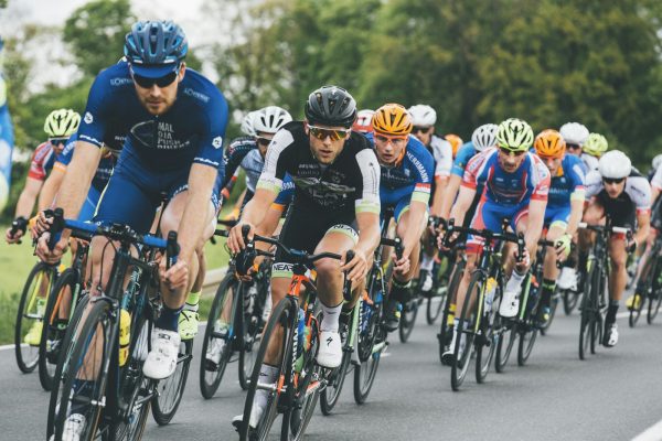Large professional cycling peloton showing how riders cluster together to benefit from the draft